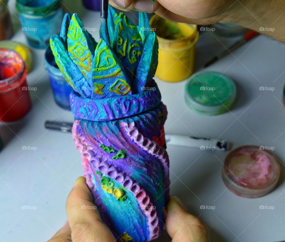 my home workshop for pouring and painting ceramic and earthenware jugs. The photo shows a jug being painted with acrylic.