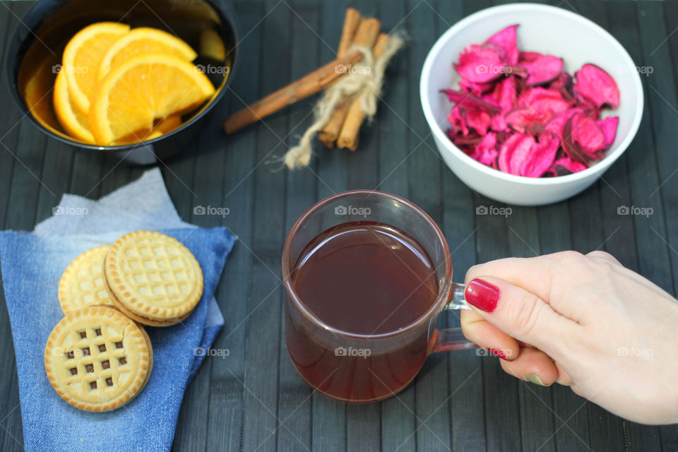 Hand holding cup of tea