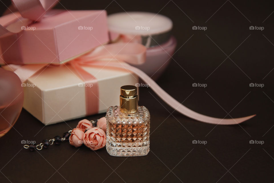 Beauty and cosmetics. Perfume bottles over black background.