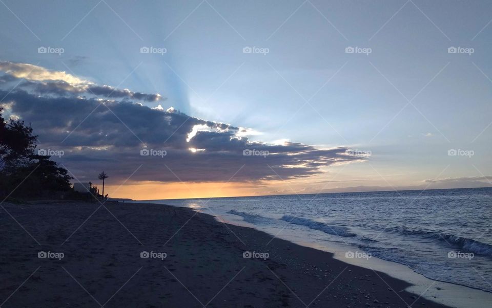 beautiful sky during sunset, sun behind a cloud