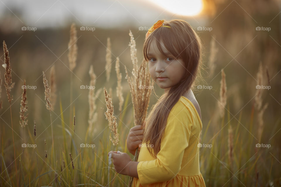 Little girl in yellow dress outdoor portrait 