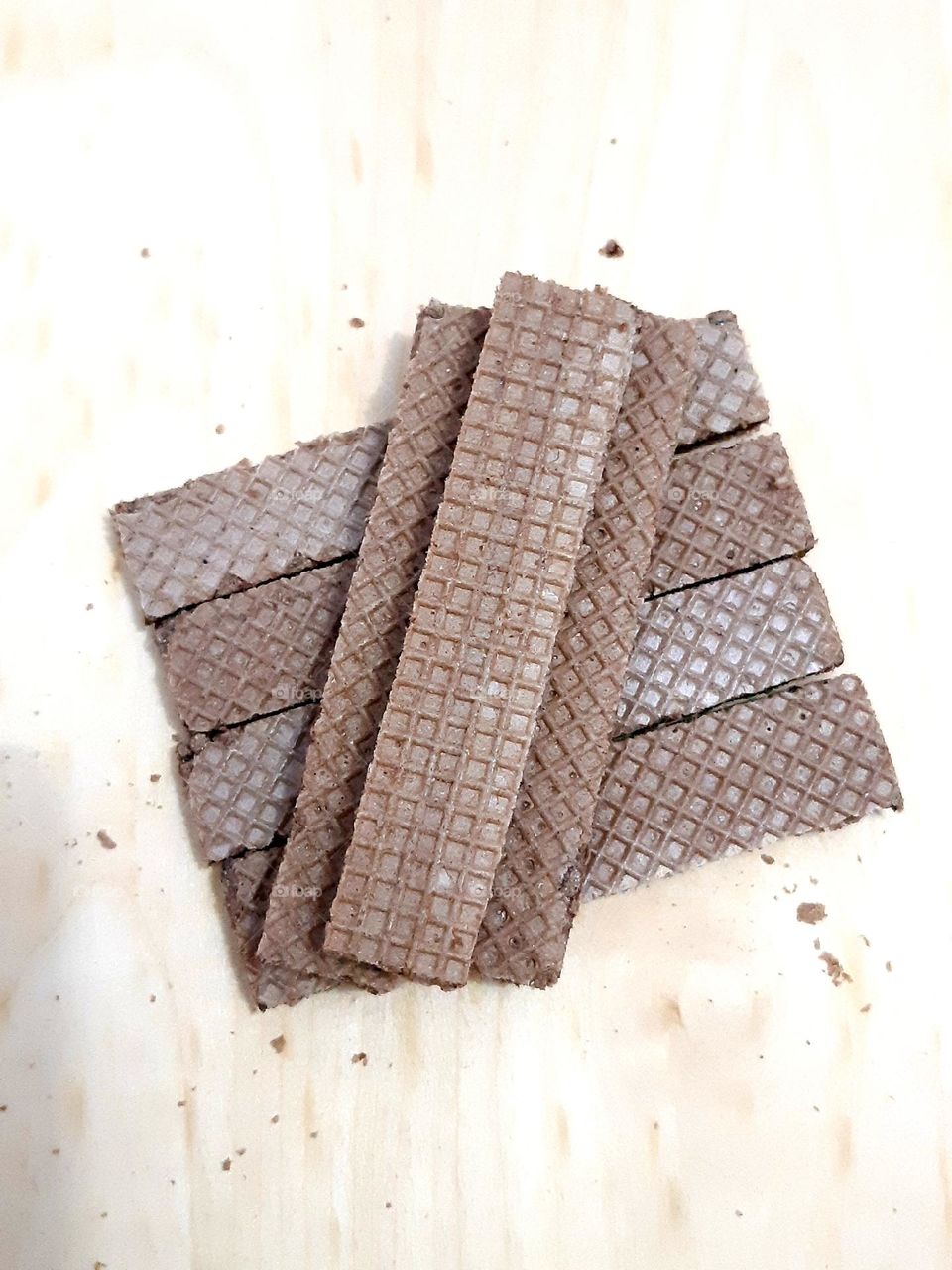 Close up pile of delicious wafer cream chocolate bar isolated on wooden background