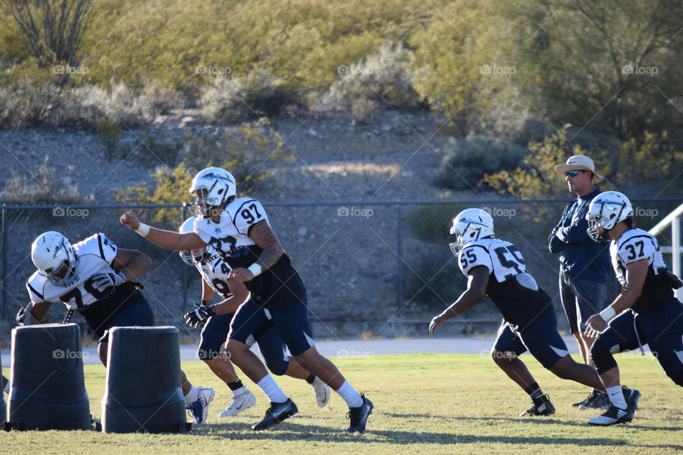 Football team practice in a campus' ballpark