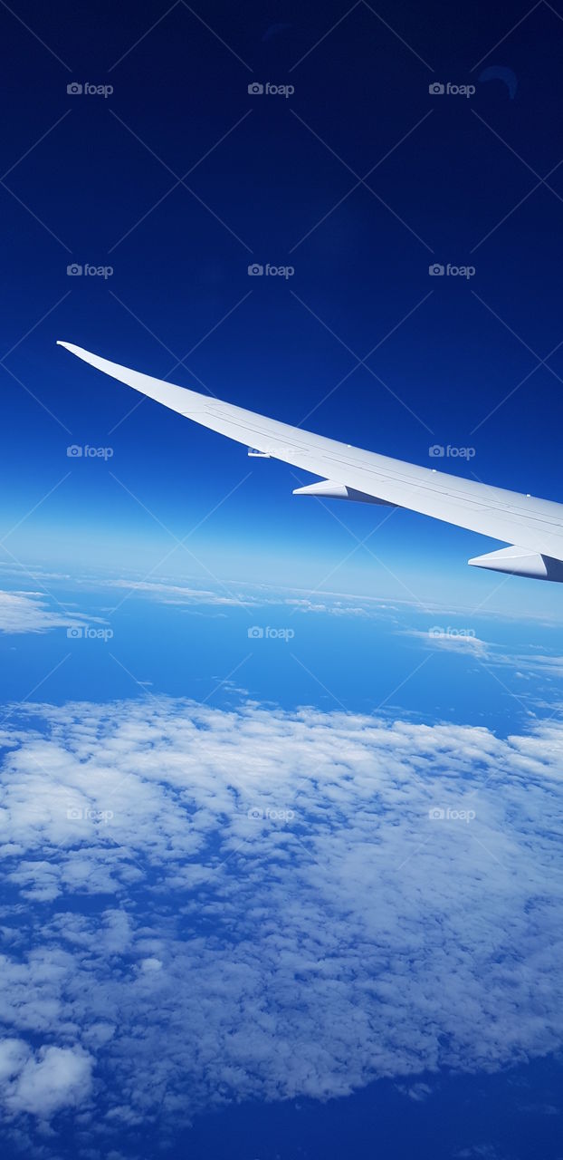 A beautiful view of blue sky from the plane window