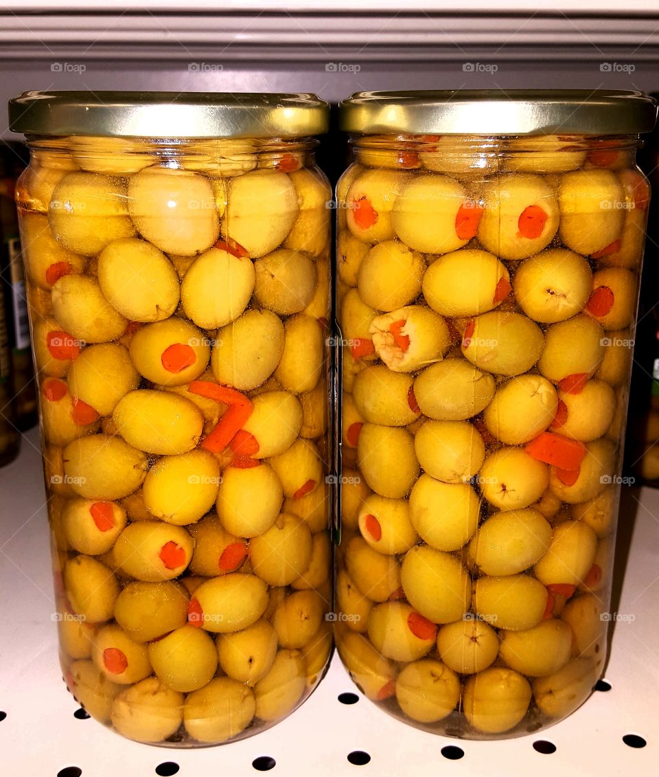 Olives in tall jars.