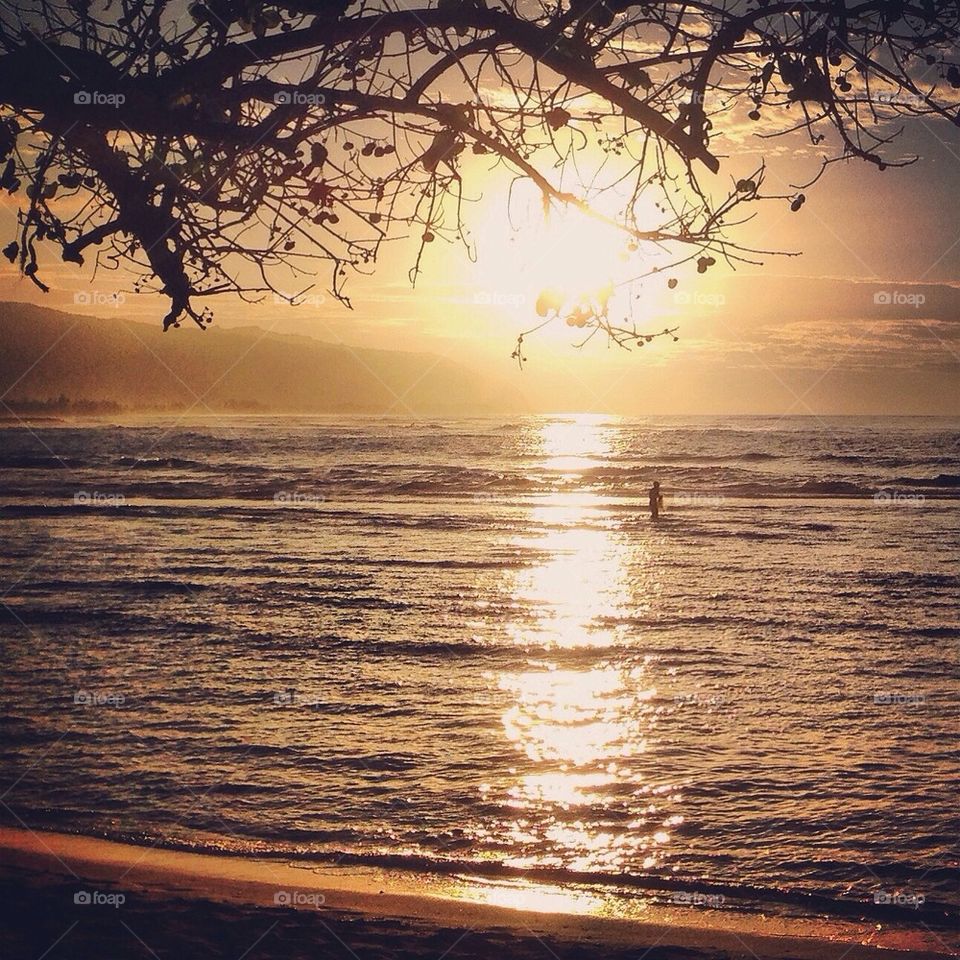 Lone fisherman at sunset