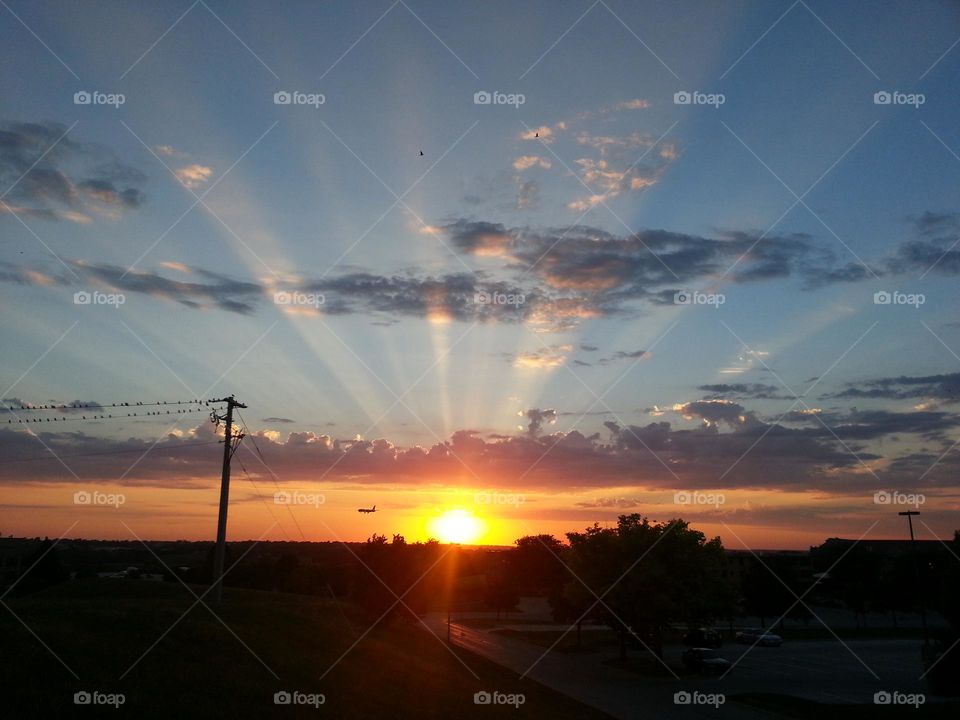 Sunset rays over a hill