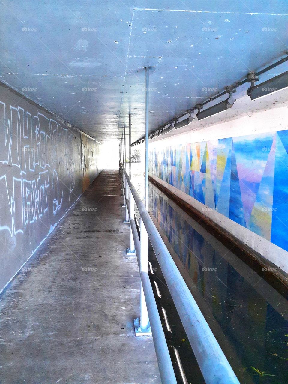 The tunnel leading from Lale Minnehaha to another park. There is graffiti on the wall, and the acoustics are great in the tunnel.