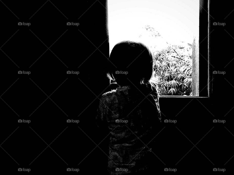 Child looking out of a window