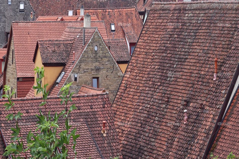 View of the red-tiled roofs of houses in a city