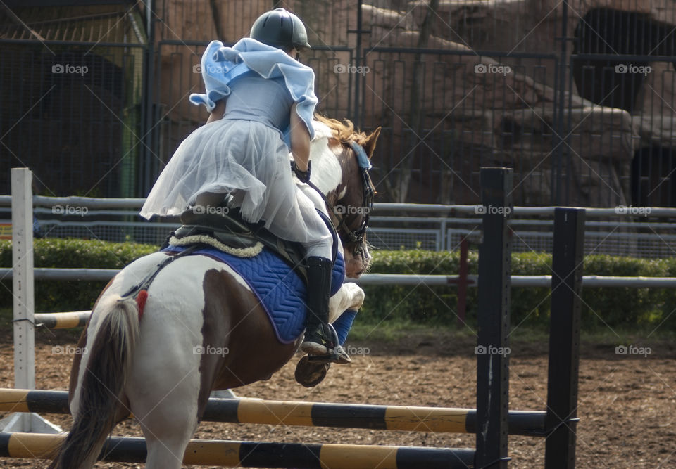 a girl is riding a horse