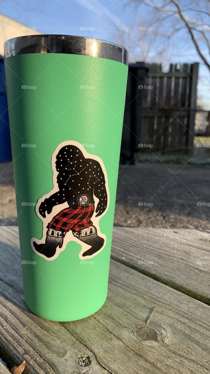 Bigfoot loves trekking in winter weather. Here he is, wearing plaid shorts, on the front of a Hydro Flask travel mug.