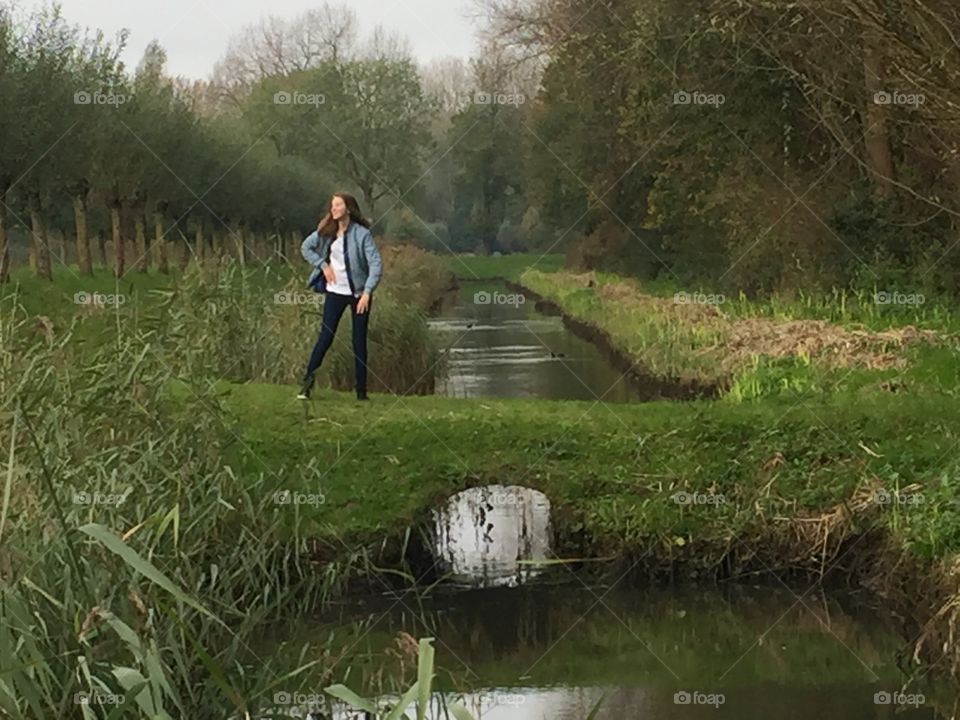 Girl near a creek. Biesbosch in Holland