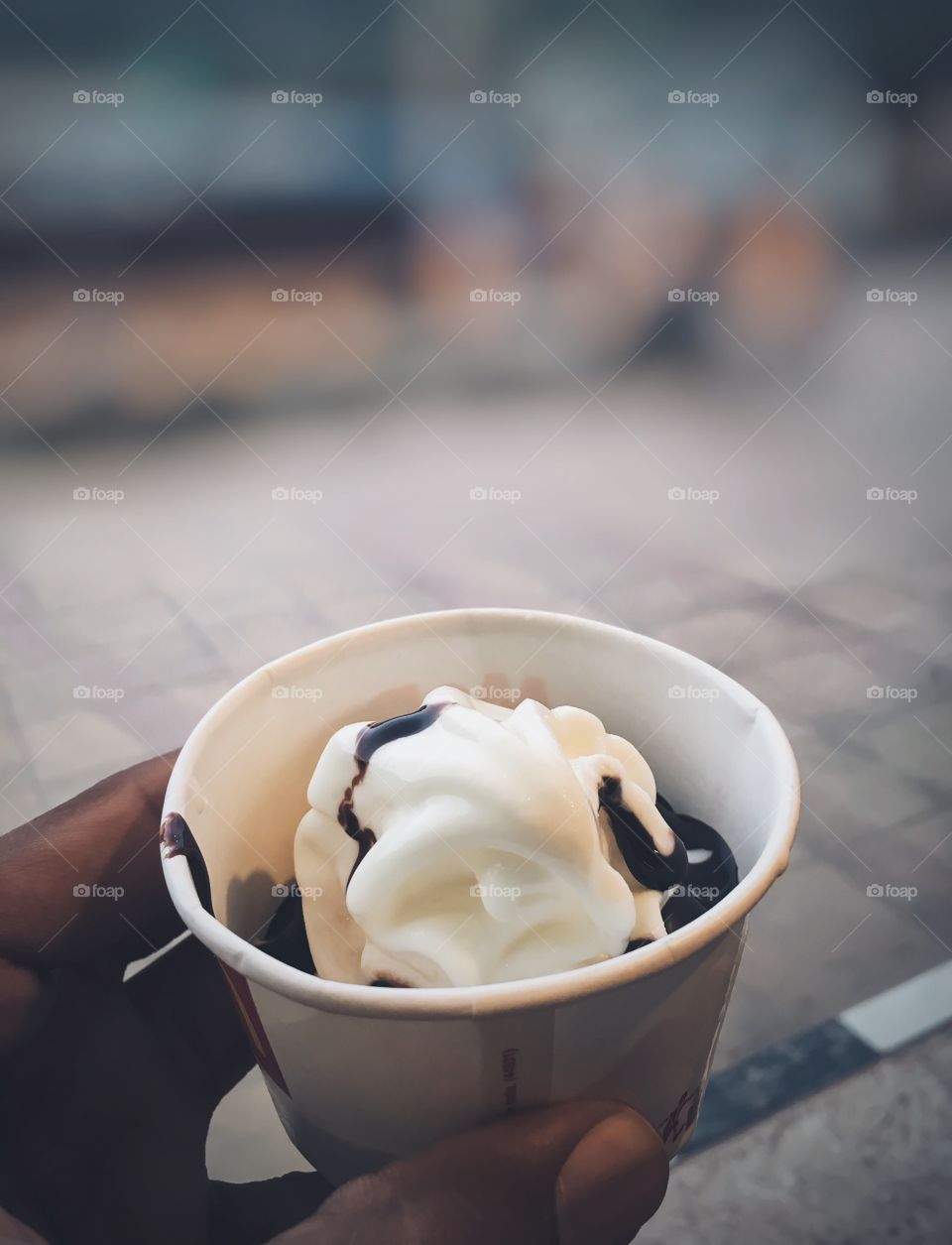 Hand holding cup of ice cream
