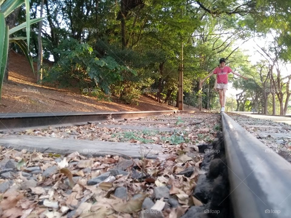 Person balancing on a railway track