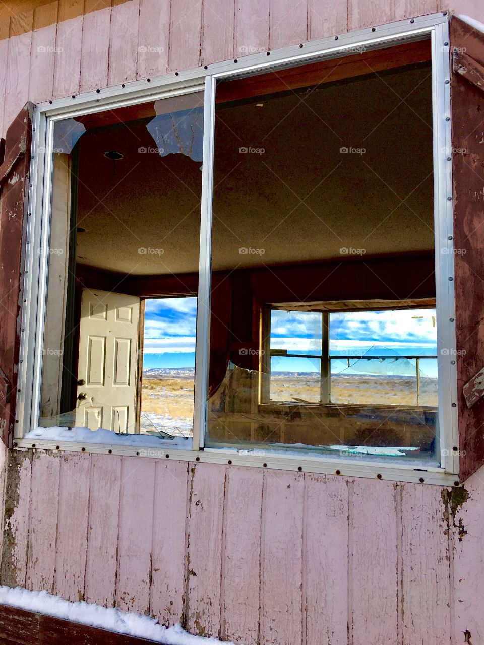 Prairie view thru an abandoned trailer 