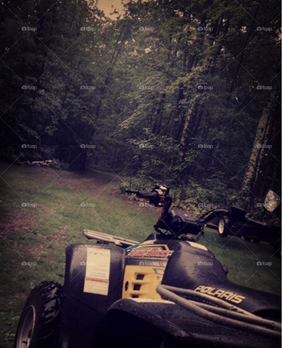 Rainy ATV ride in the woods.