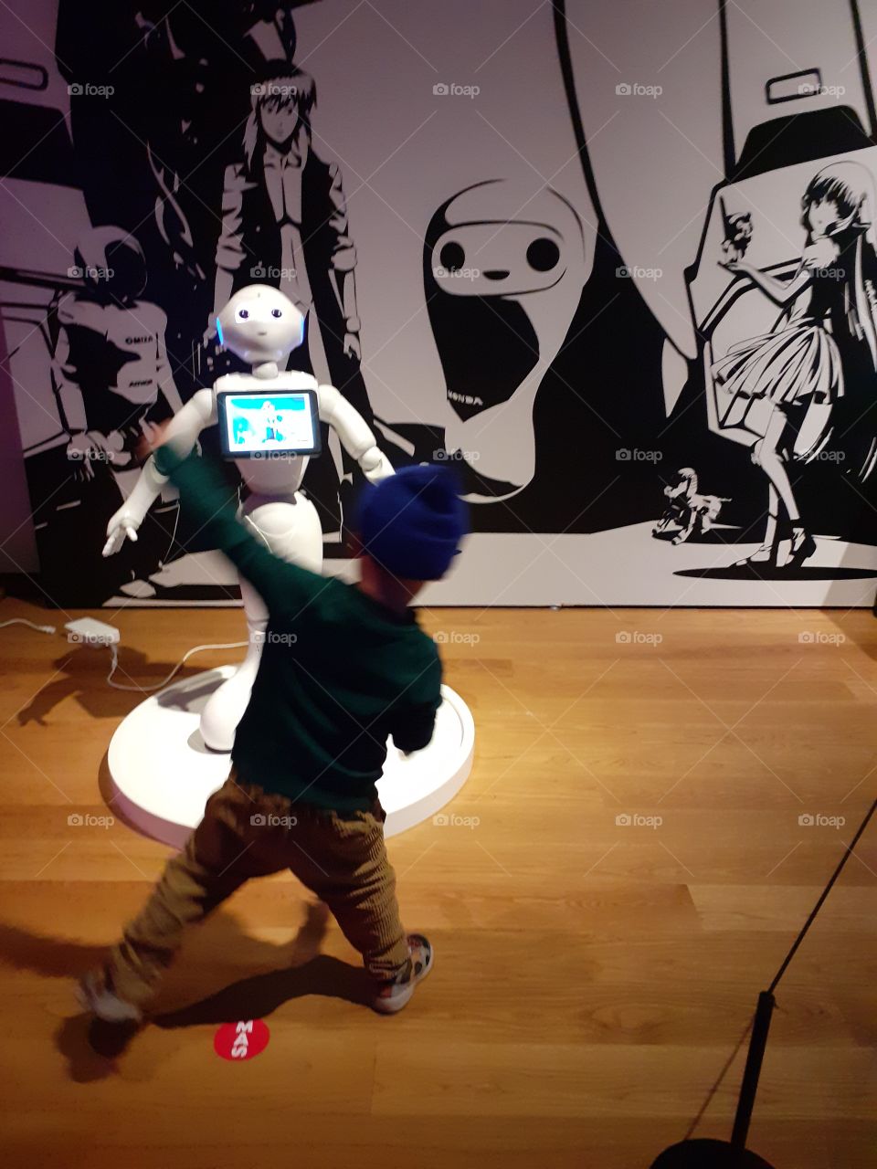 dancing child with dancing robot at COOL JAPAN MAS museum Antwerp