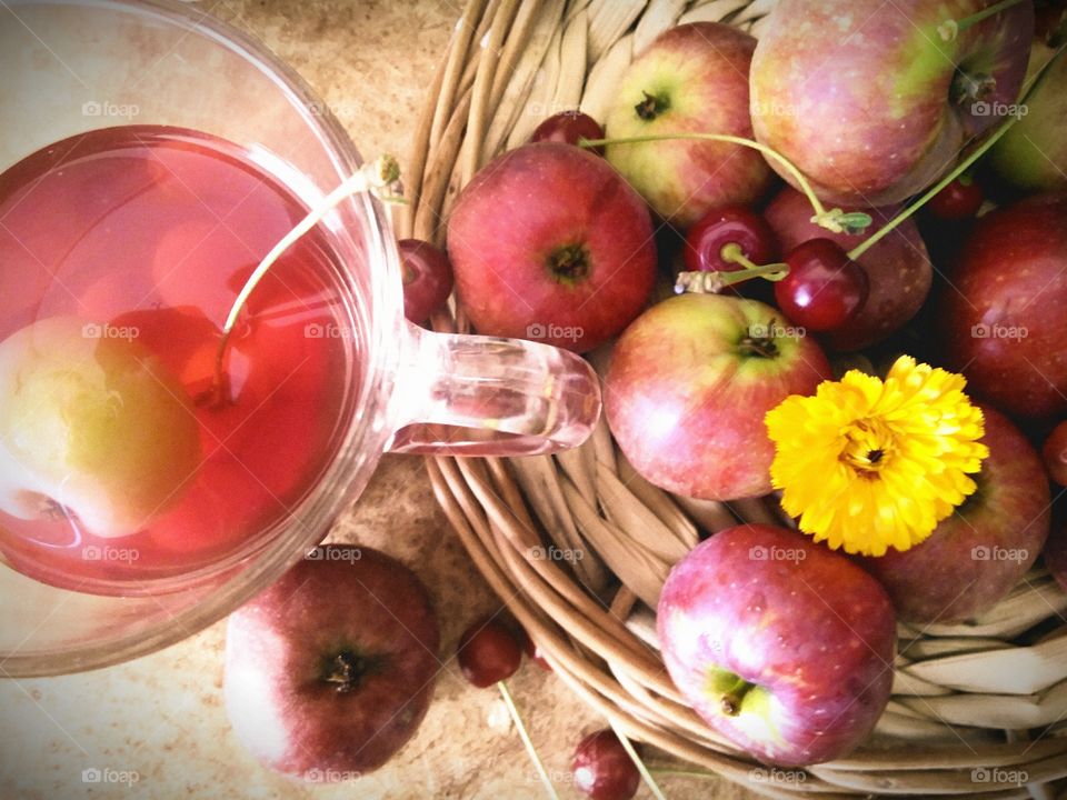 fruit composition - apples, cherries and a glass with compote.