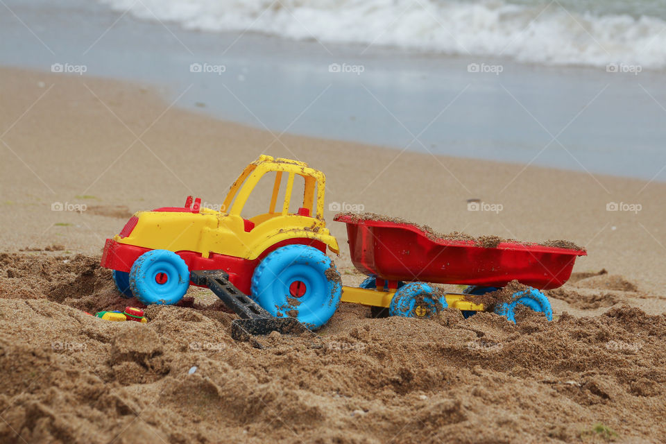 Summertime and toy track on the beach