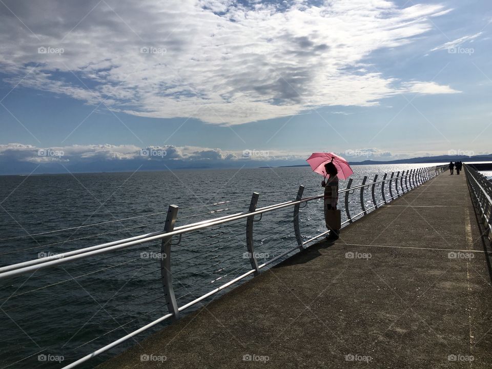 The woman with a pink umbrella