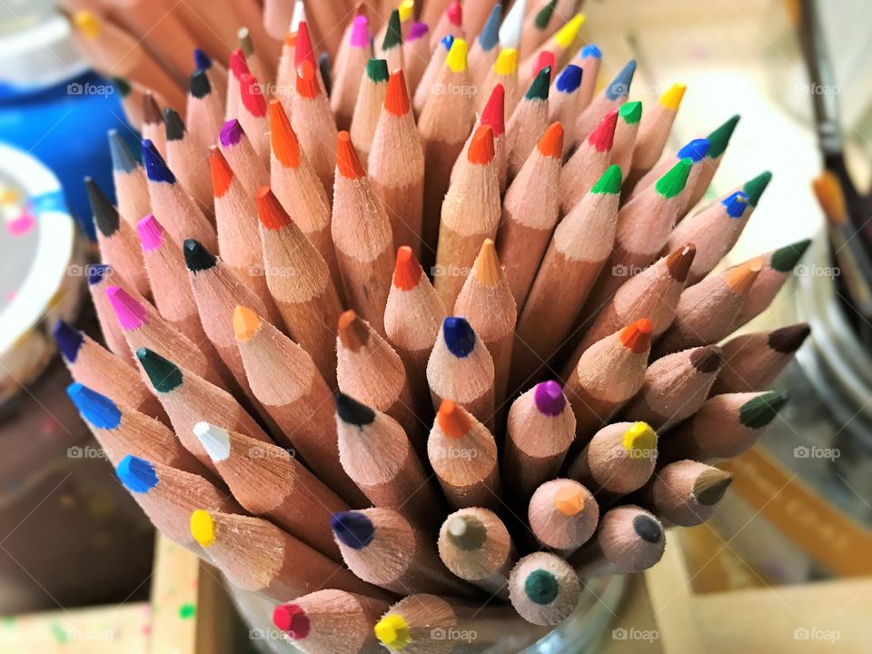 Pencil crayons being stored in cup