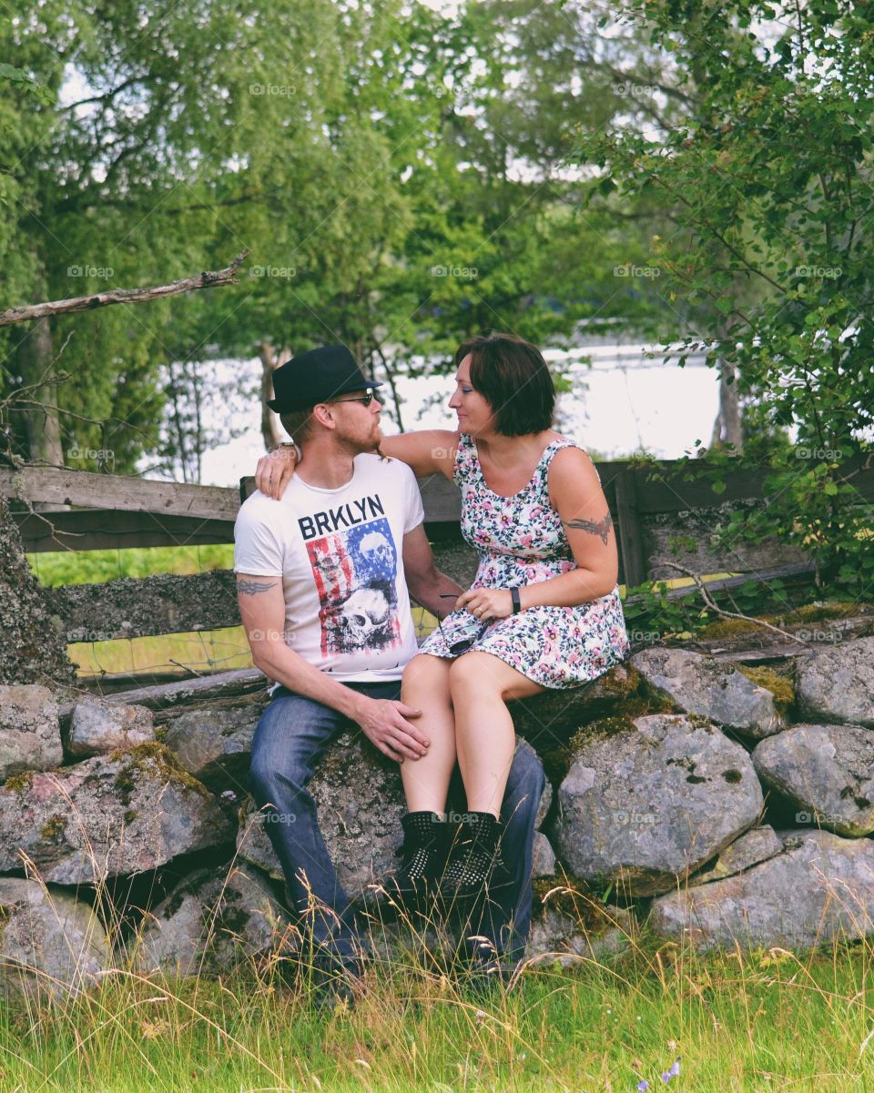 Couple sitting on a stone wall