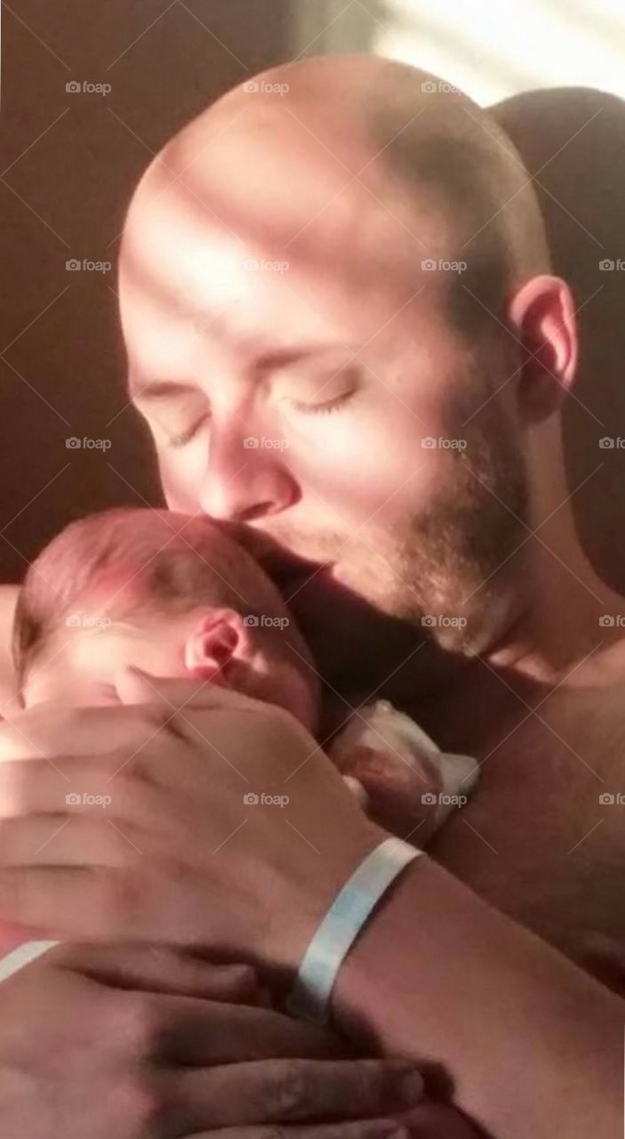 Baby kid sleeping on father's chest