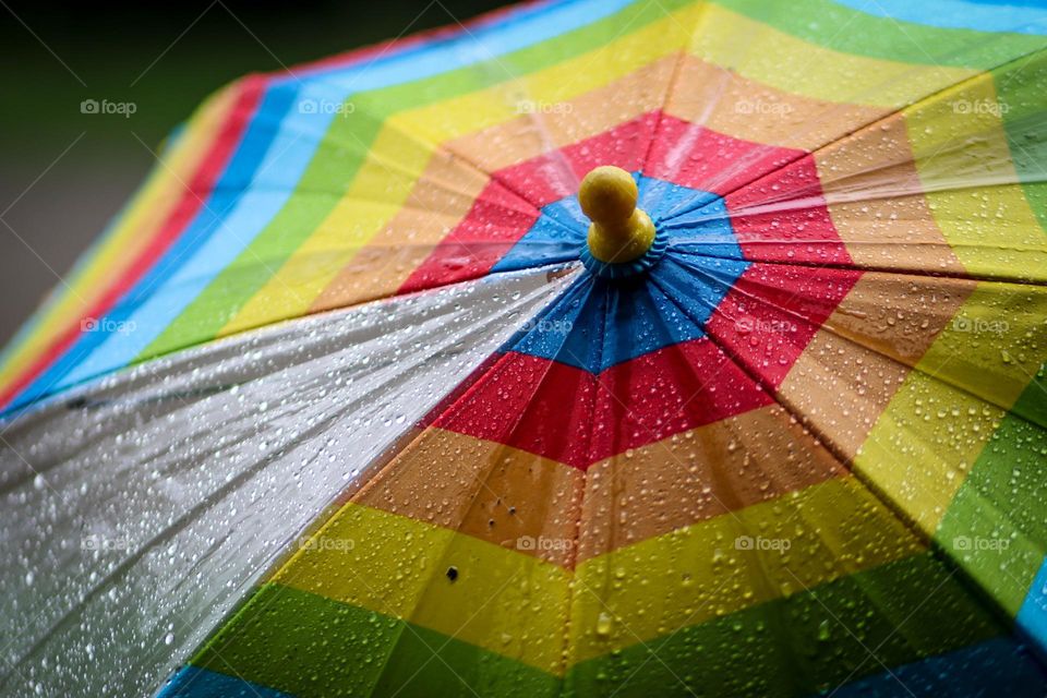 Raid drops on a colorful umbrella