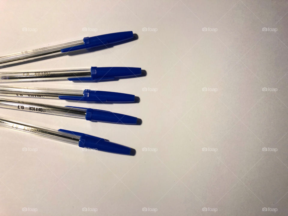 blue pens on white background
