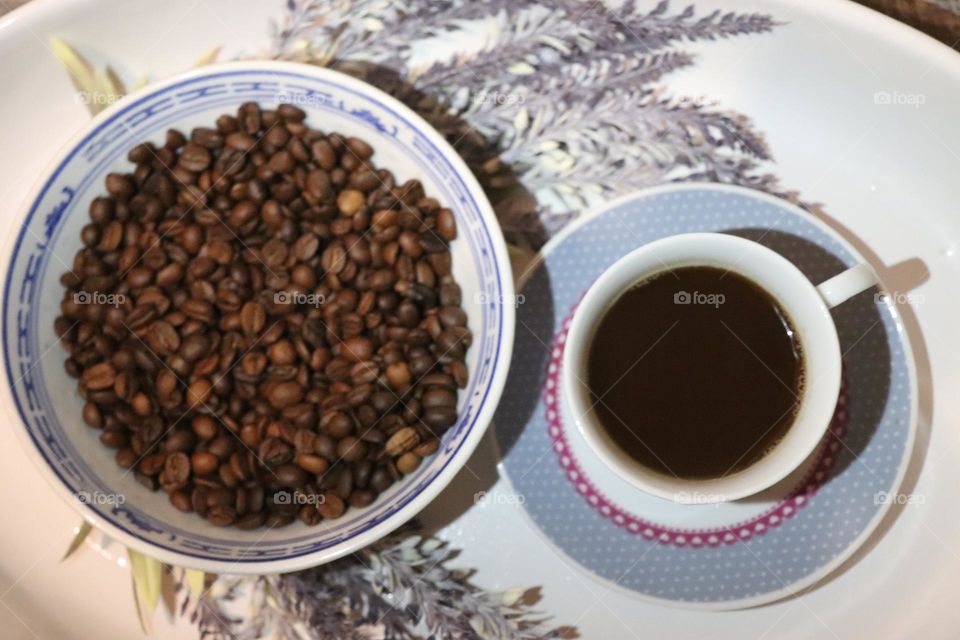 A cup of coffee and coffee beans