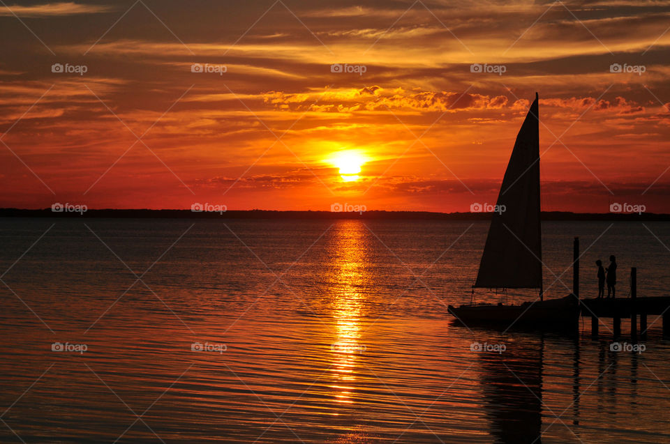 Sunset Over the Bay with Sailboat