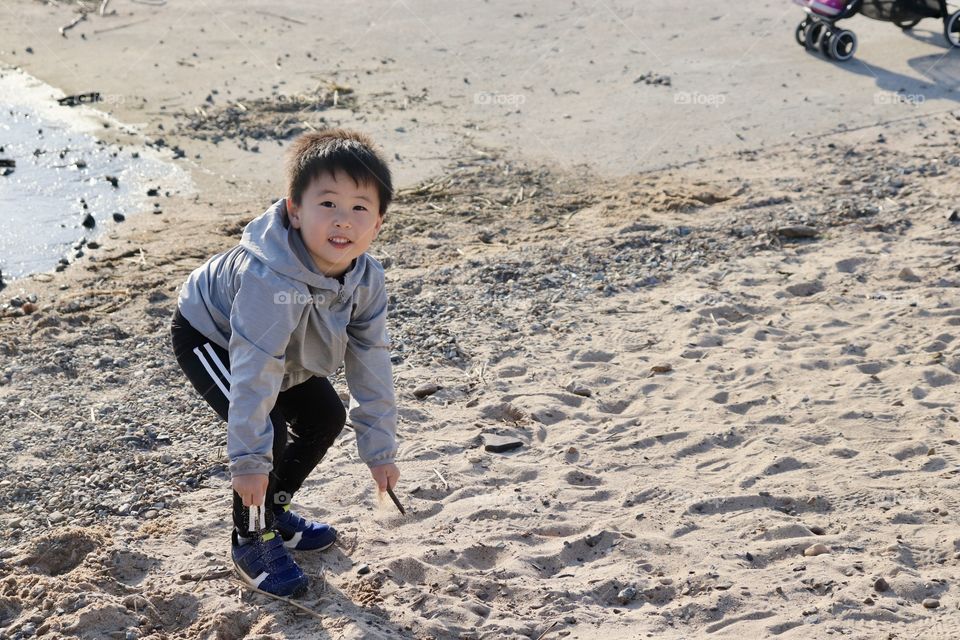 Korean kid playing in the beach 