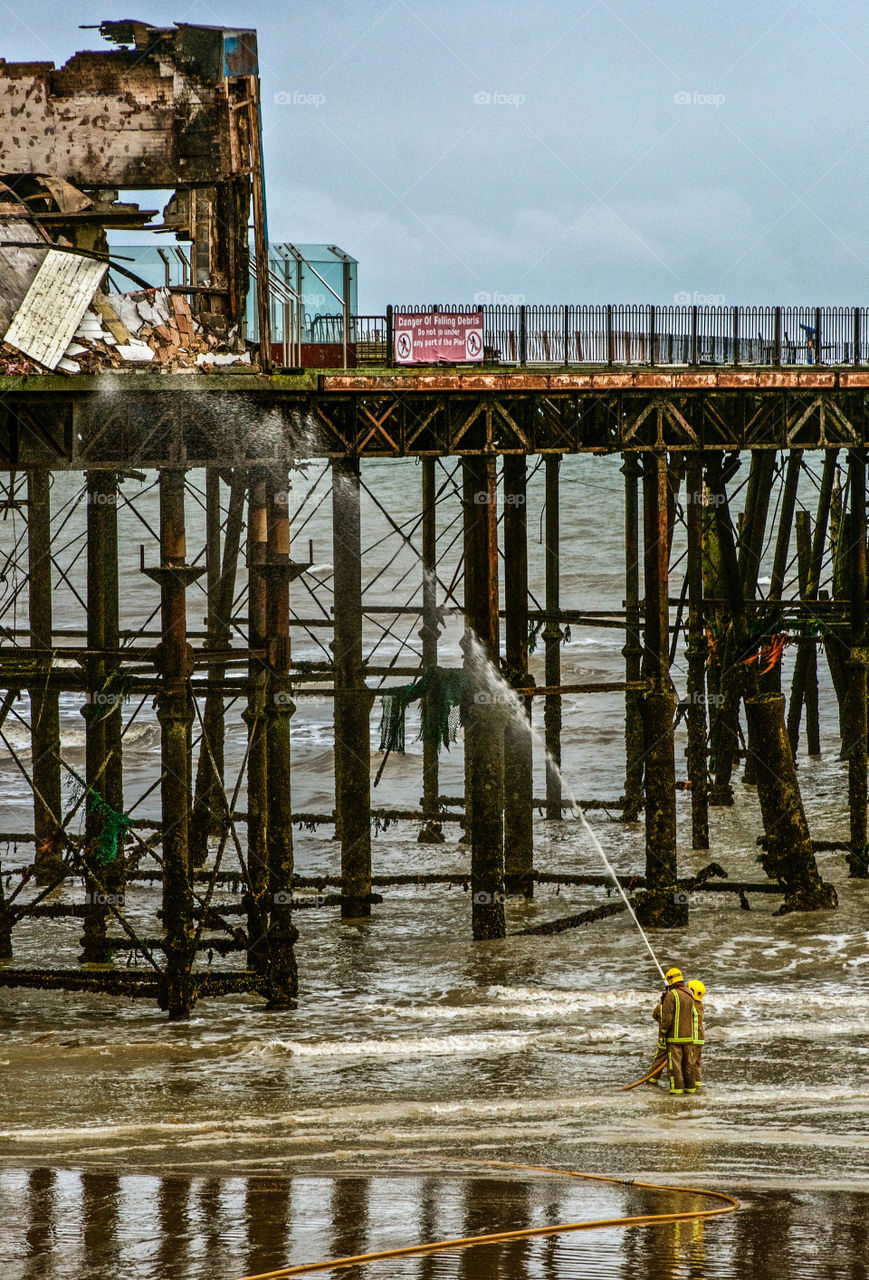 Fire fighters still trying to put out the fire, the day after the Hastings pier fire, October 2010, UK 