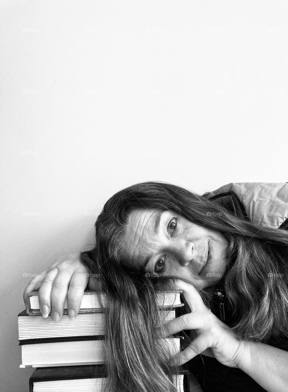 iPhone portrait - black and white woman with book stack.