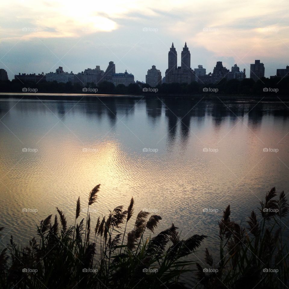 New York skyline reflected in the central
Park reservoir at sunset
