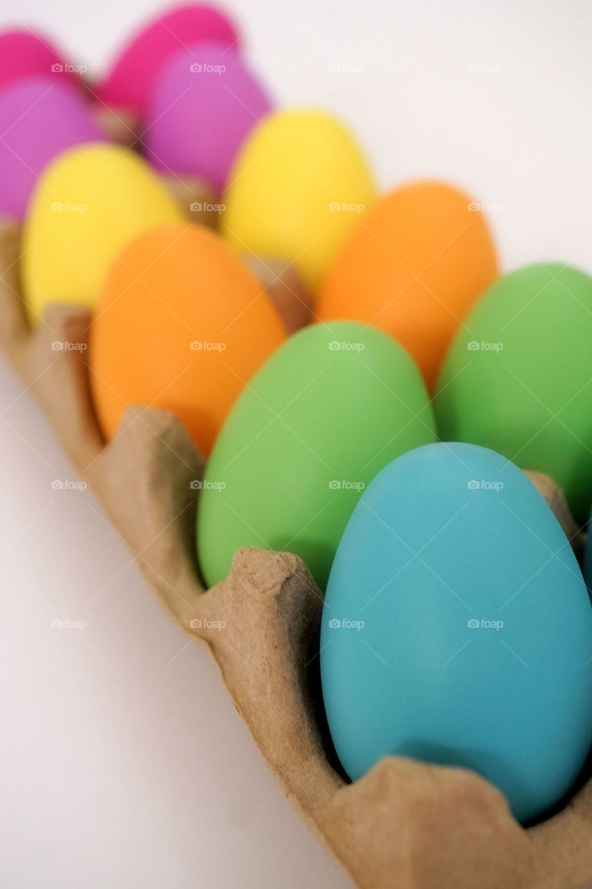 Colorful easter eggs in egg carton