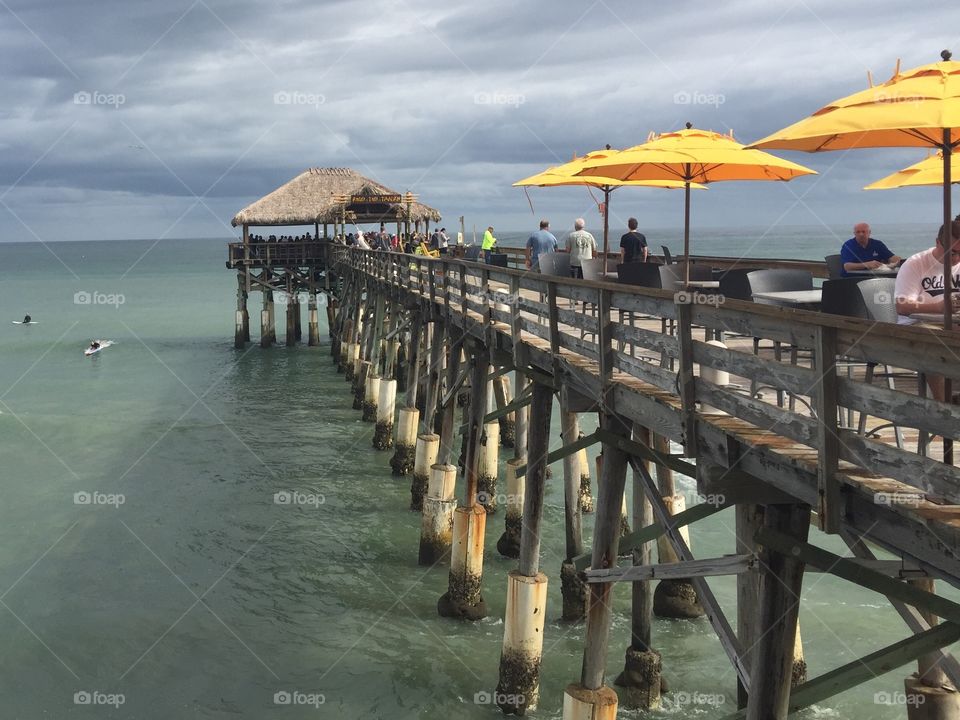 Fishing Pier with bungalow and yellow umbrellas 