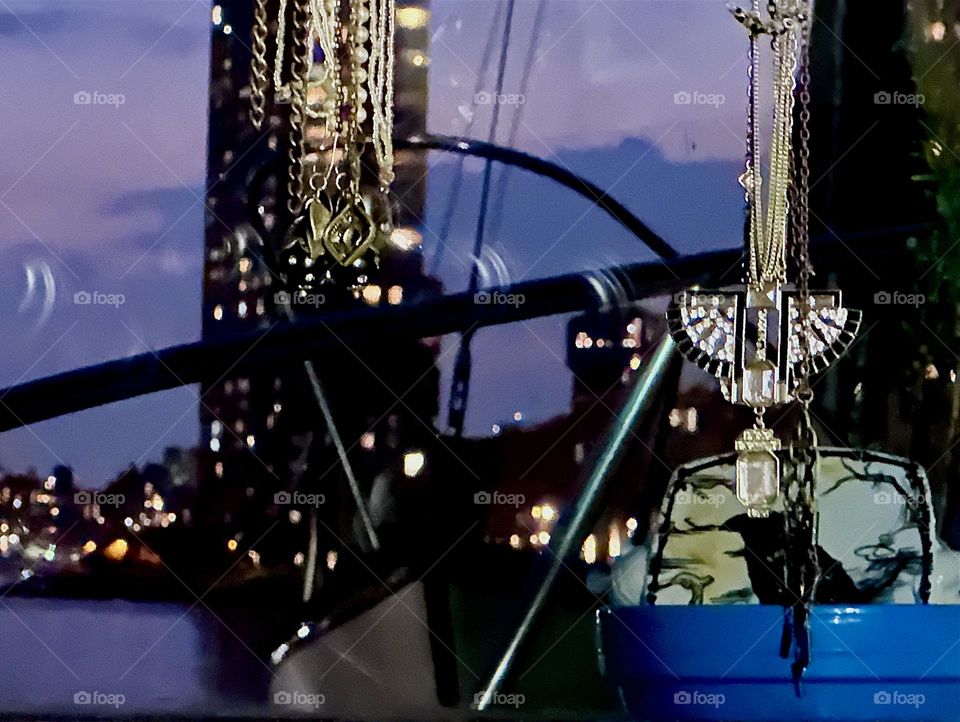 As the hours progress the sky turns increasingly purple seen from “Salvation”, our “28 ft 1969 Luhrs” cabin cruiser at “Newtown Creek” by the “Pulaski Bridge” in LIC. Across the water we see a “Greenpoint”, Bklyn high rise. 2024. Hypnotic Productions