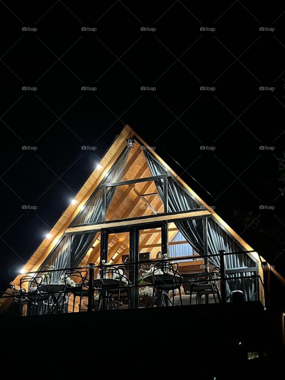 The windows of this beautiful forest cottage twinkling beautifully under the night sky. But who knows what is hidden behind this beauty?