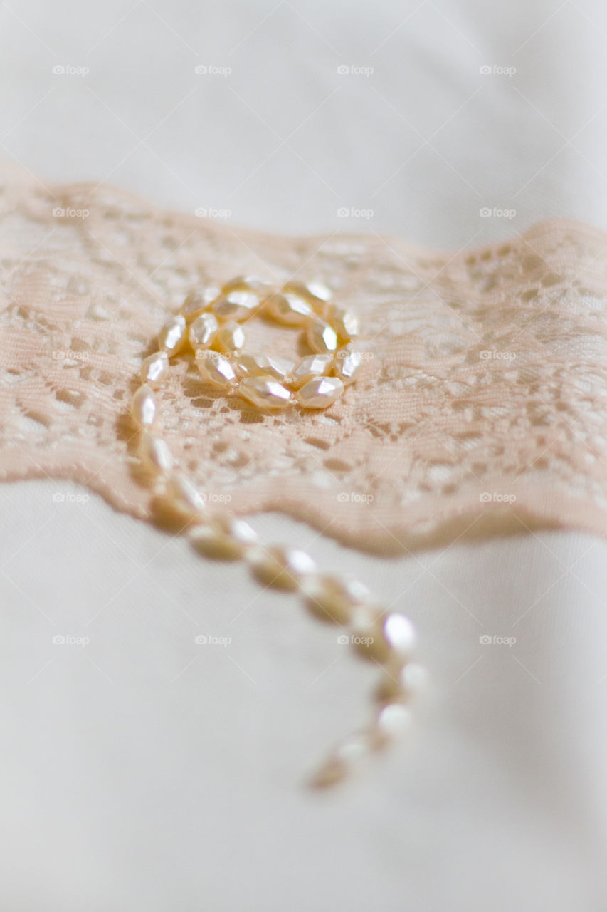 Cream and white monochrome image - pearls and lace