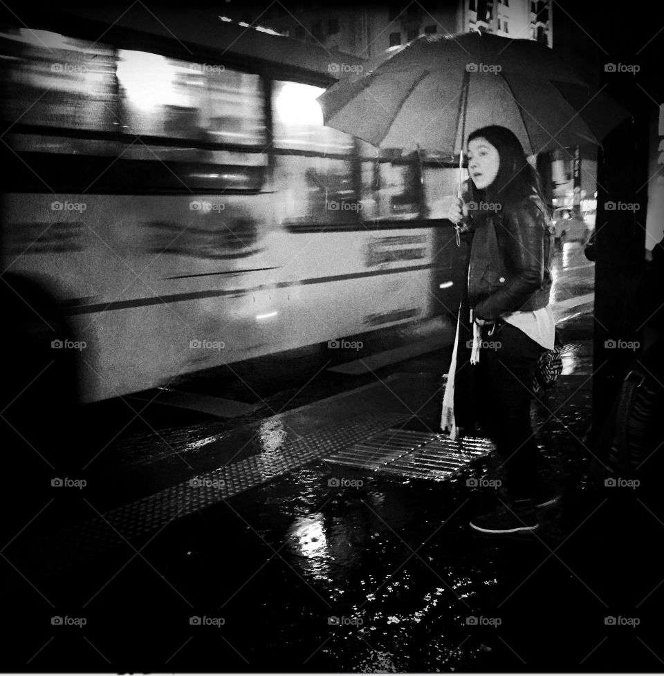 Black and white girl in the rain with umbrella