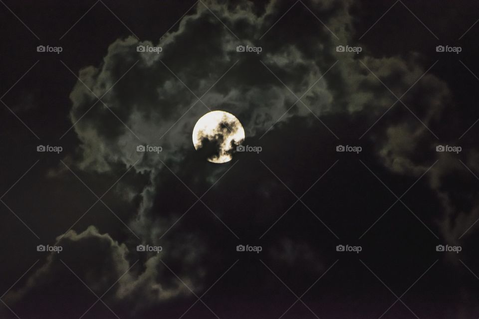 Moon in cloudy sky during night
