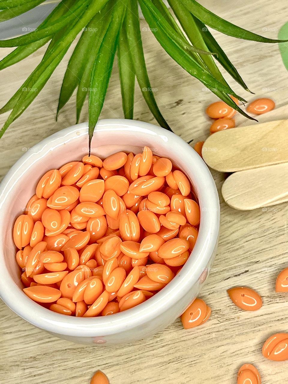 Depilatory wax in a white ceramic container