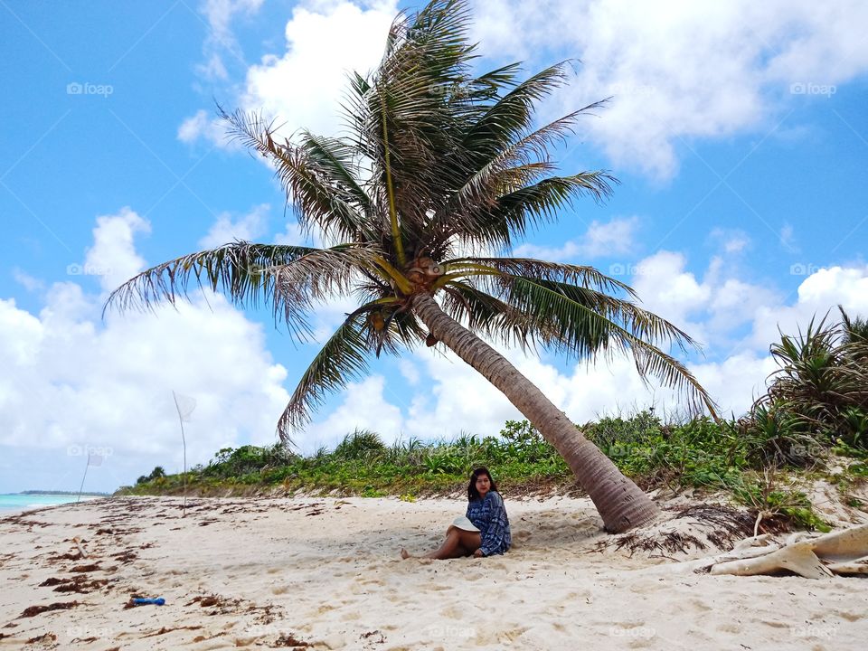 relaxing under the coconut tree.