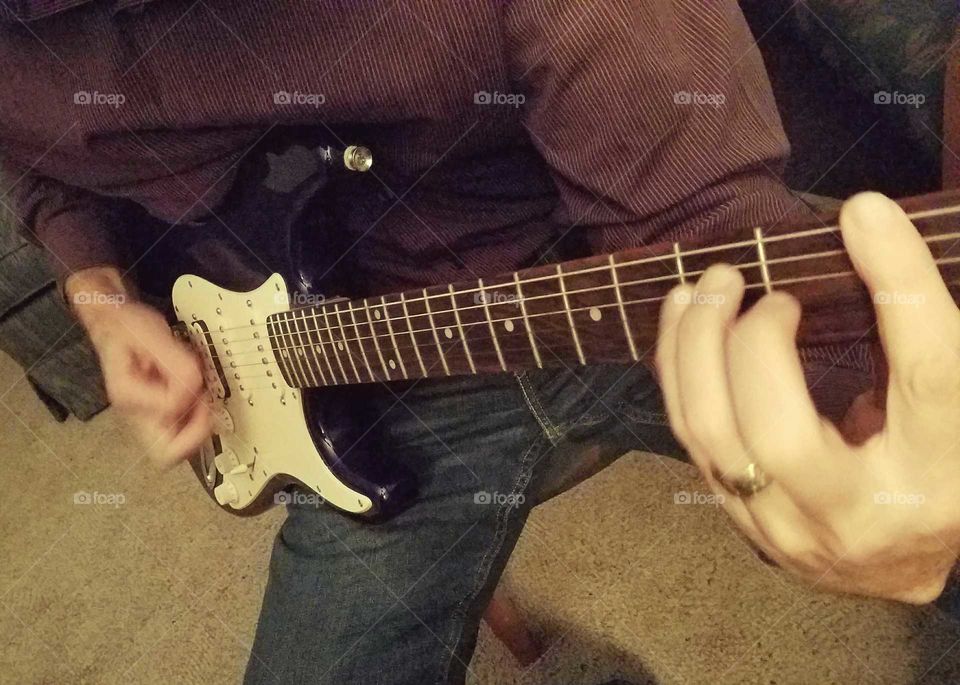 Man's Hands Playing Fender Stratocaster Guitar