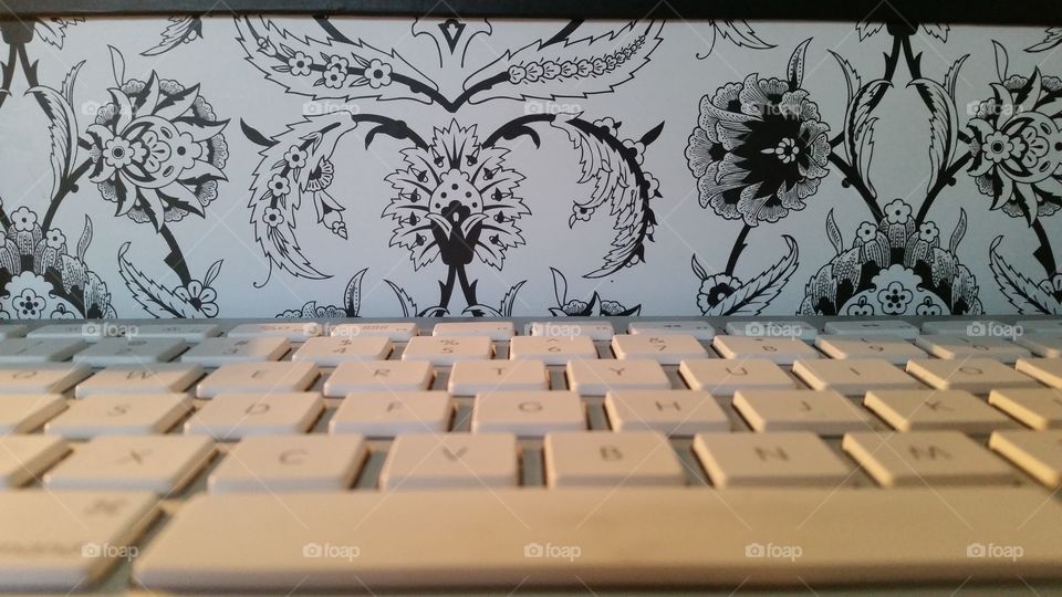 Keys to the Universe. Computer keyboard and abstract floral