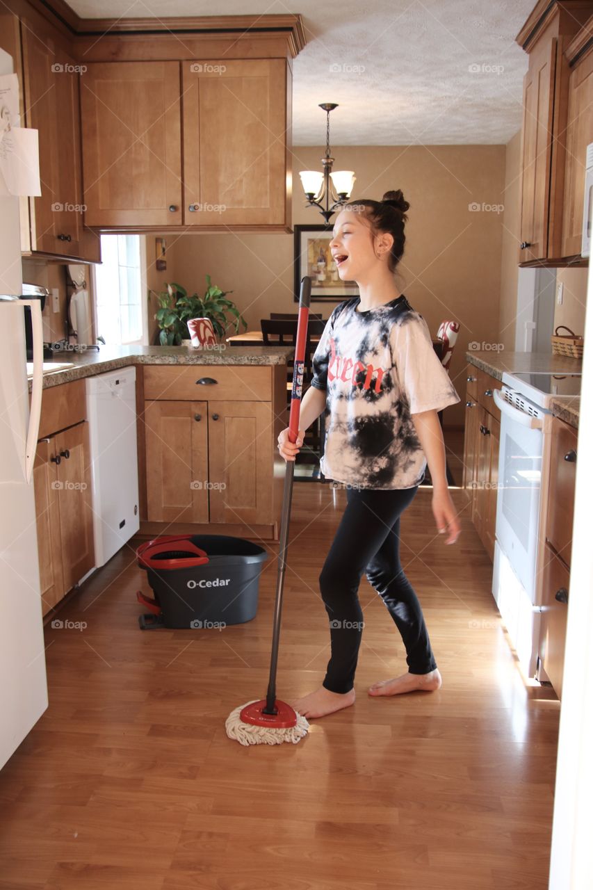 Girl using O-Cedar mop and bucket 