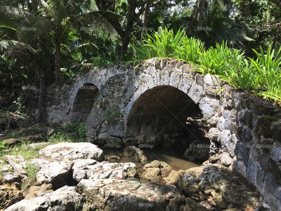 Cetti Bay bridges - Guam. Stream runs below them, to the rocky beach towards the ocean 