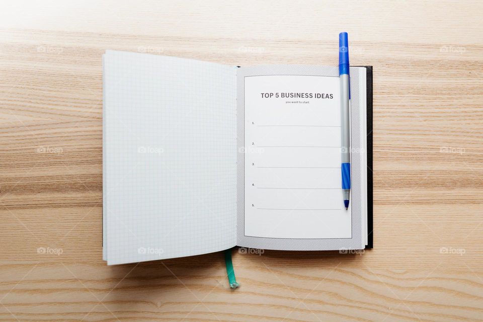 Open Journal With Top Five Business Ideas Photo
An open notebook with a blank page titled Top 5 Business Ideas, a pen sits on top waiting to get to work.